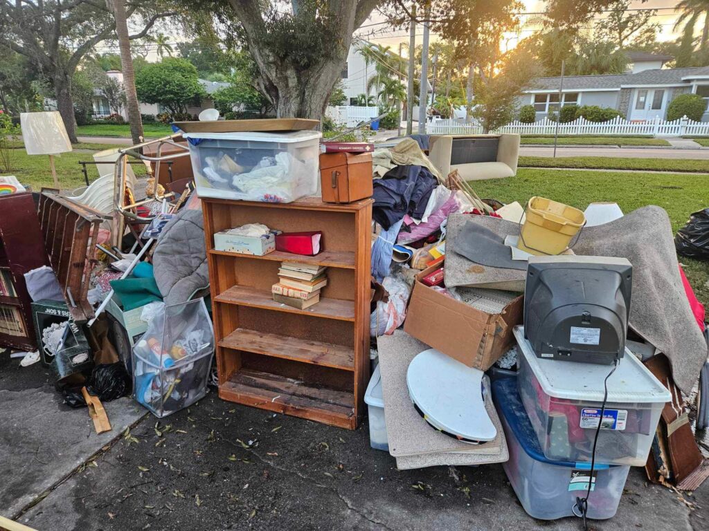 A pile of trash and junk sitting on the ground.